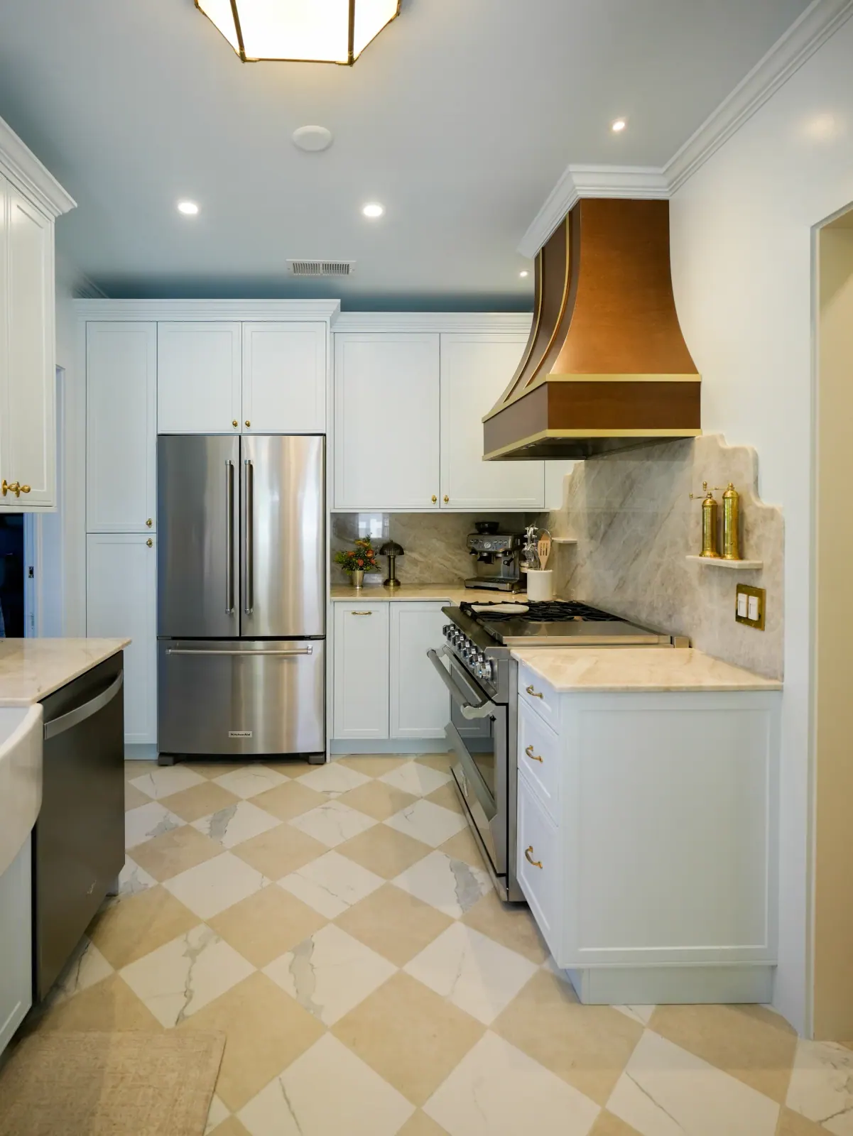 Historic-home kitchen with white shaker cabinets and a copper hood
