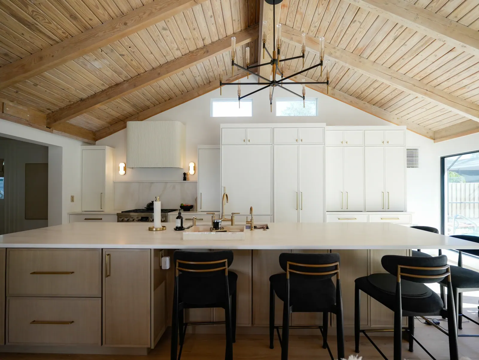 Vaulted kitchen with a tongue-and-groove ceiling and island seating